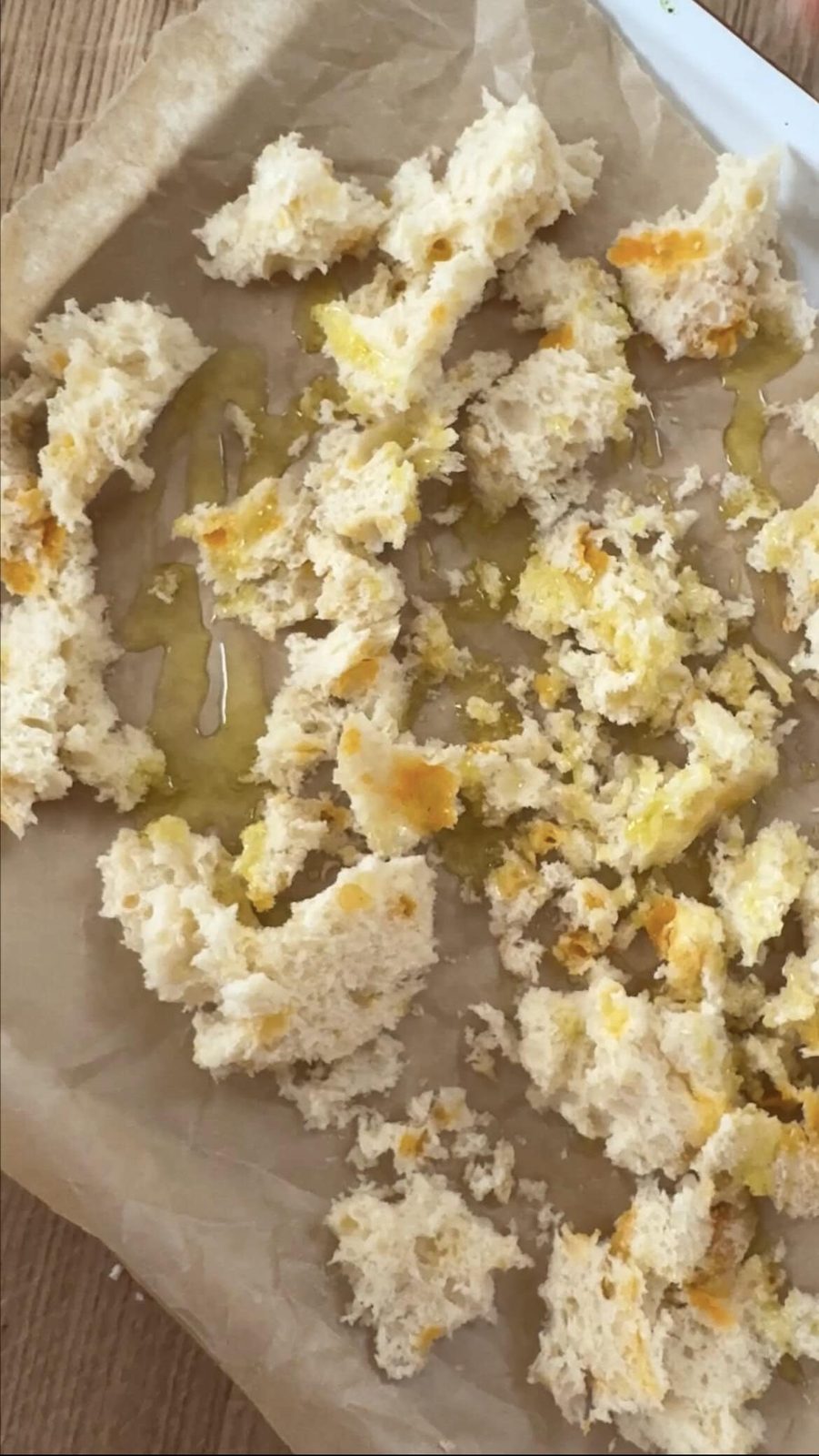 Breadcrumbs on a tray drizzled with oil, before baking
