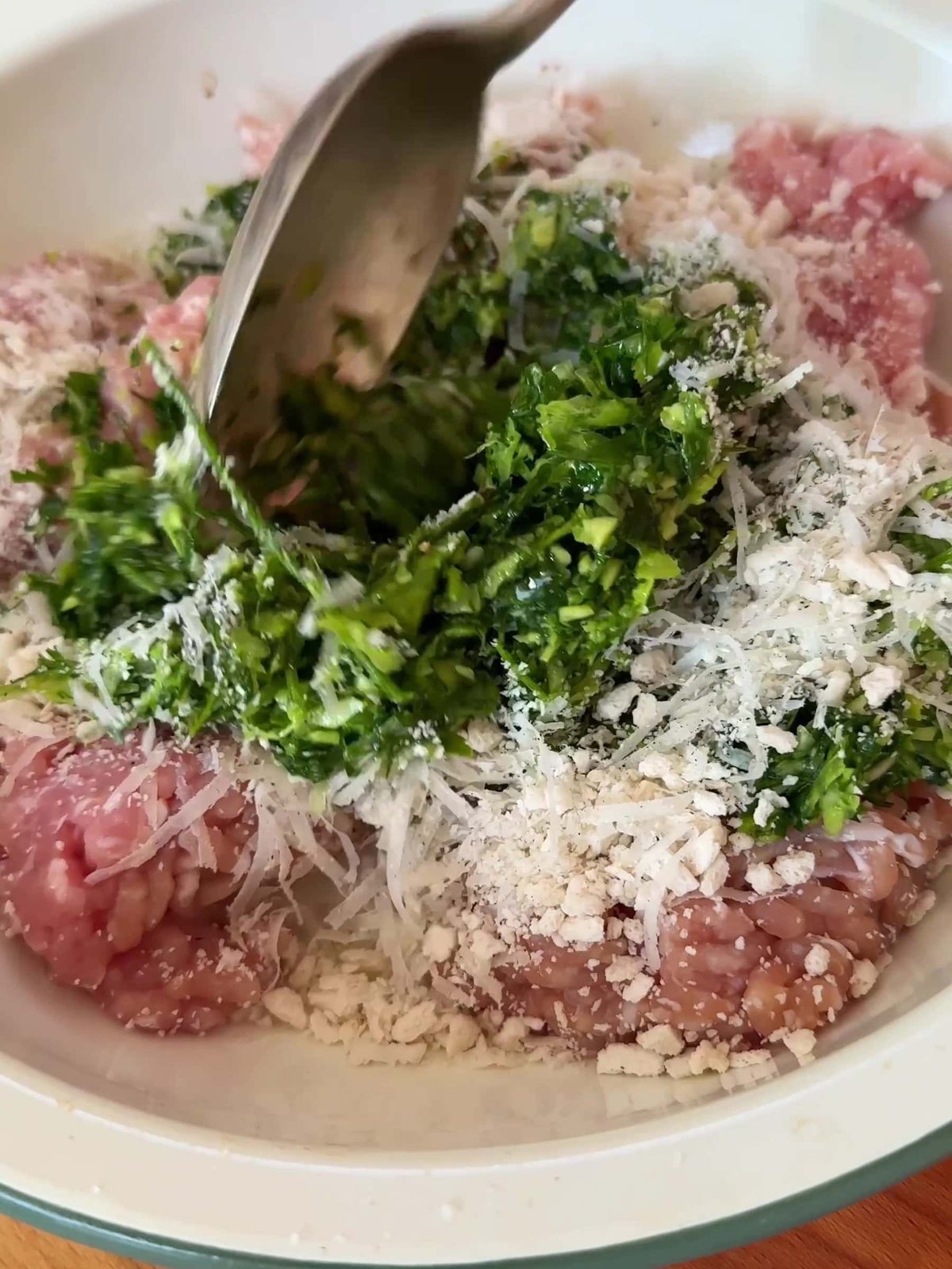 Place the chicken mince into a large bowl and add the herb mixture.