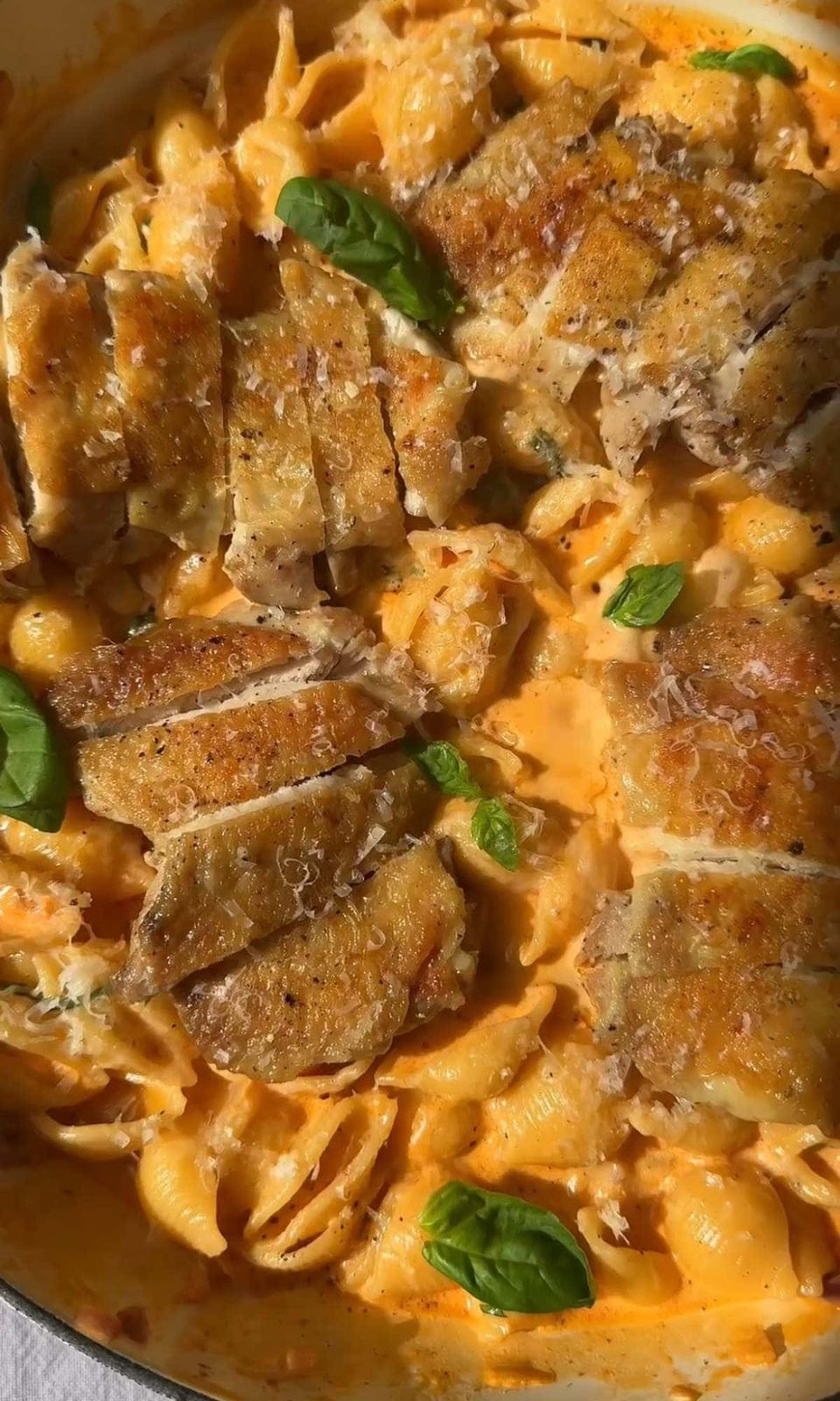 adding chicken to the parmesan garlic pasta.