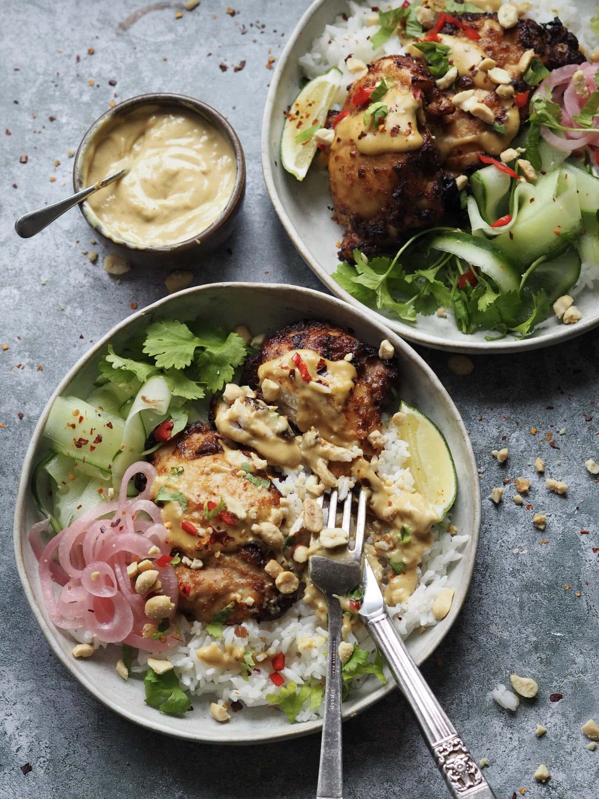 Chicken satay rice bowl in plates on table.
