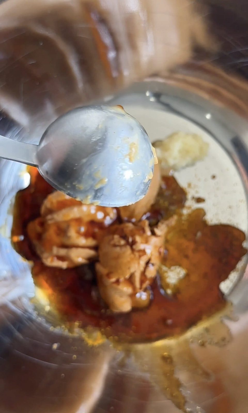 Mixing chicken satay sauce in a bowl.