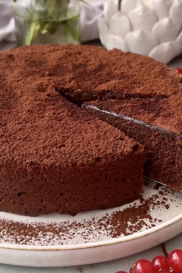 torta caprese with a slice being removed from the cake.