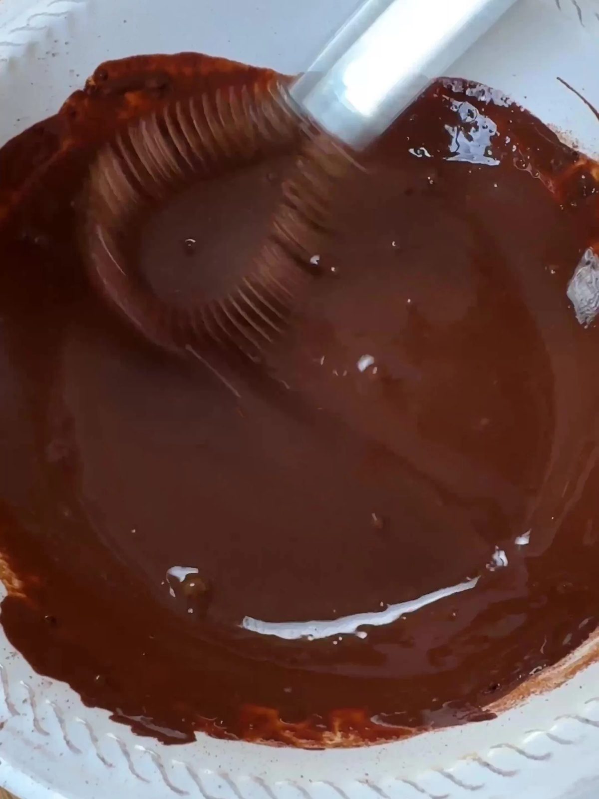 Whisking cocoa and water.