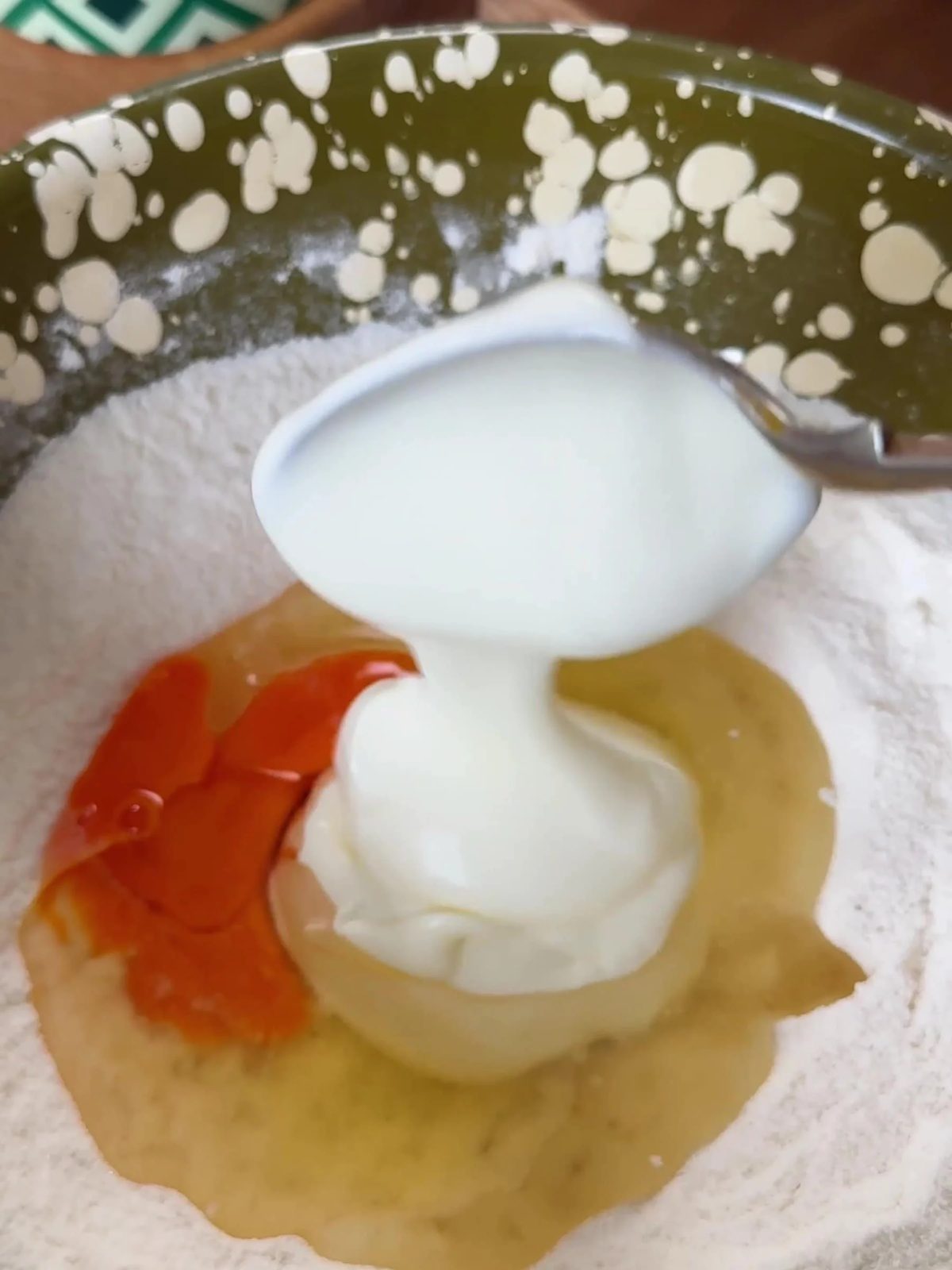 Adding yogurt and egg to dry ingredients.