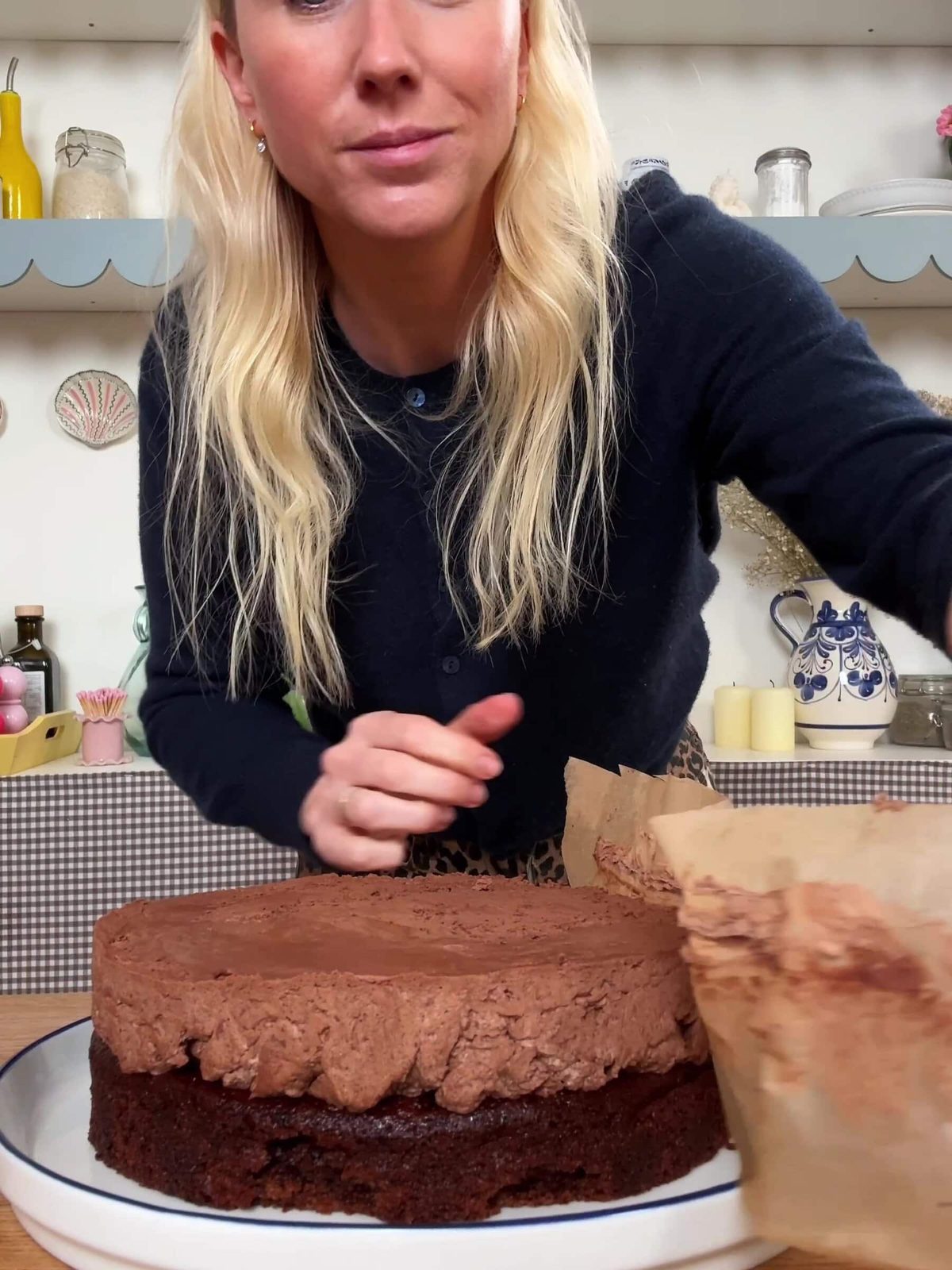 Peeling baking paper from chilled chocolate mousse cake.