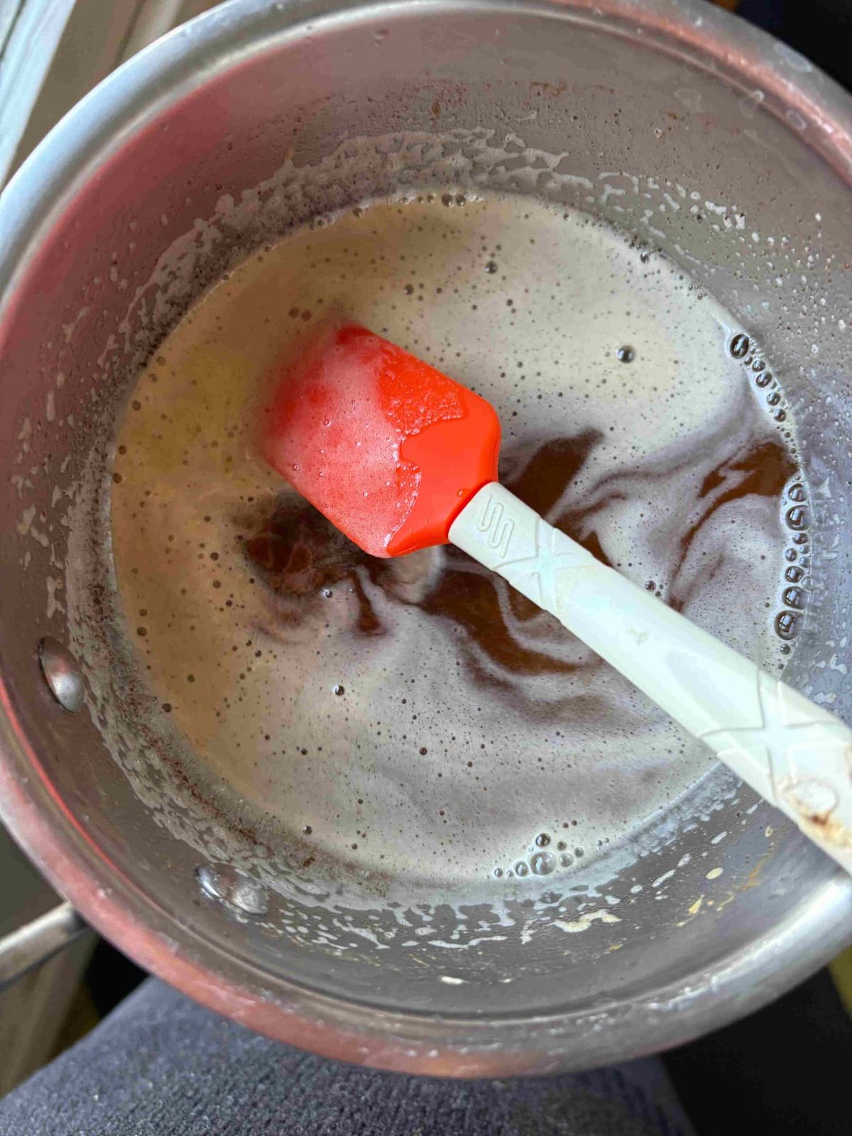 Browned butter cooling in pan with spatula.