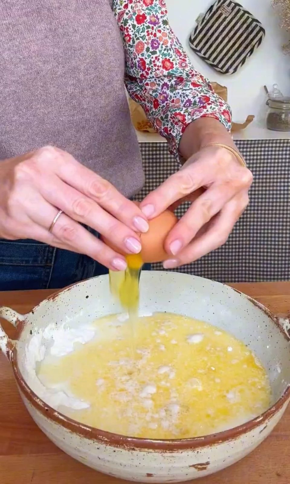 cracking eggs into pancake batter.