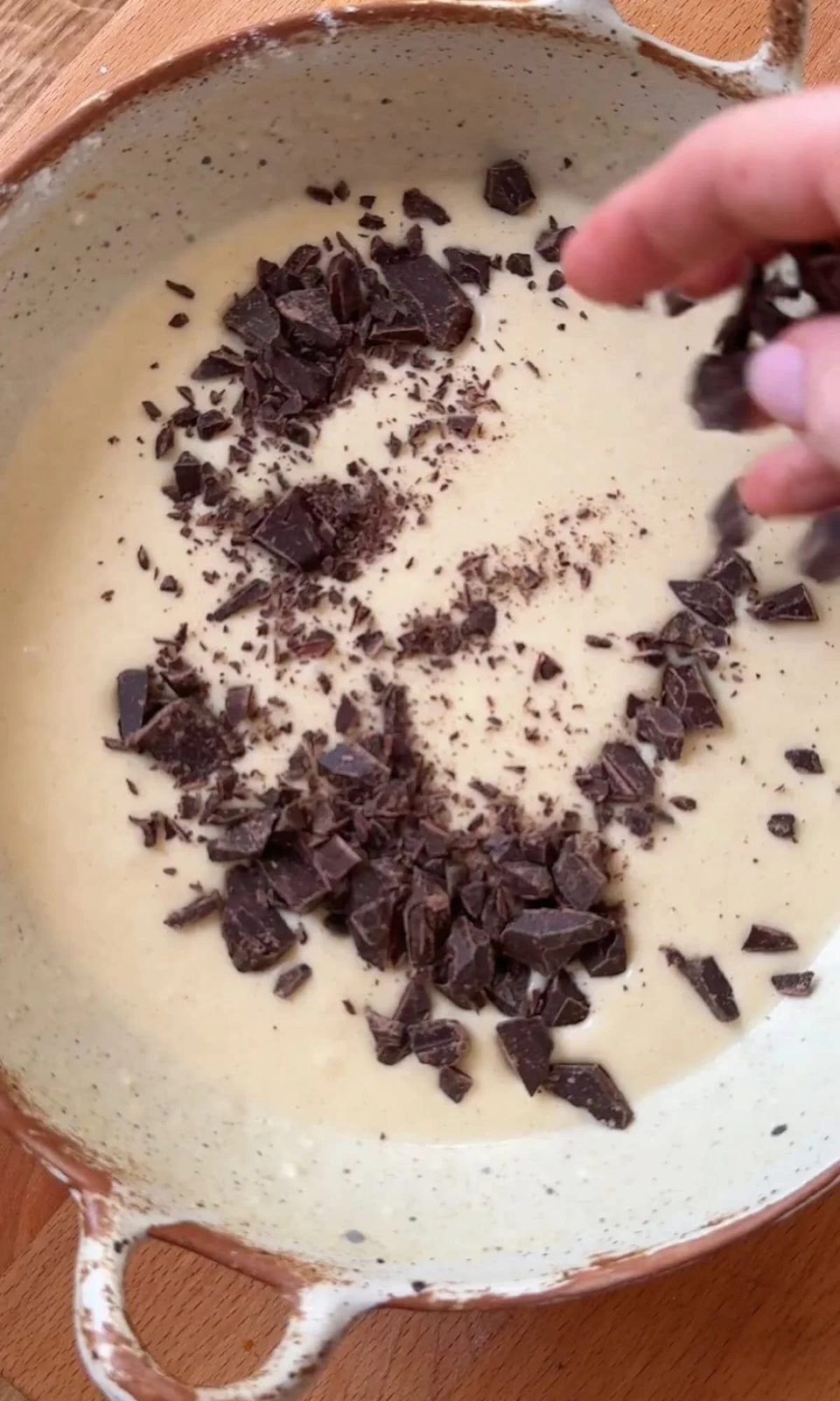 stirring chocolate chip into pancake batter.