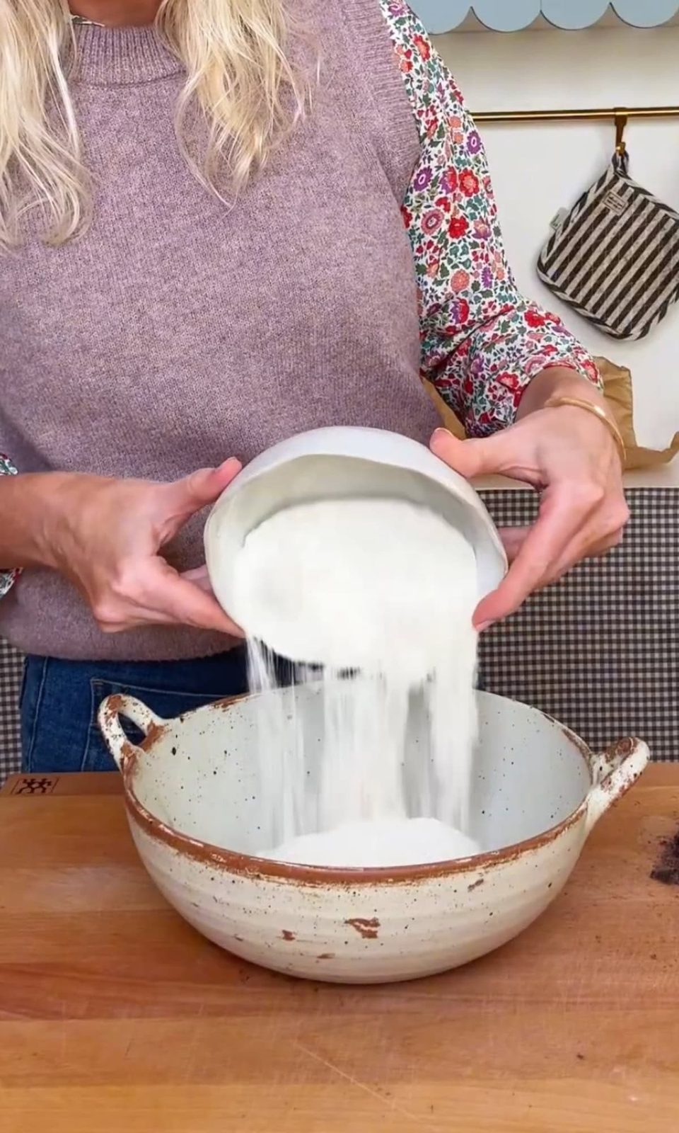 adding flour to pancake batter.