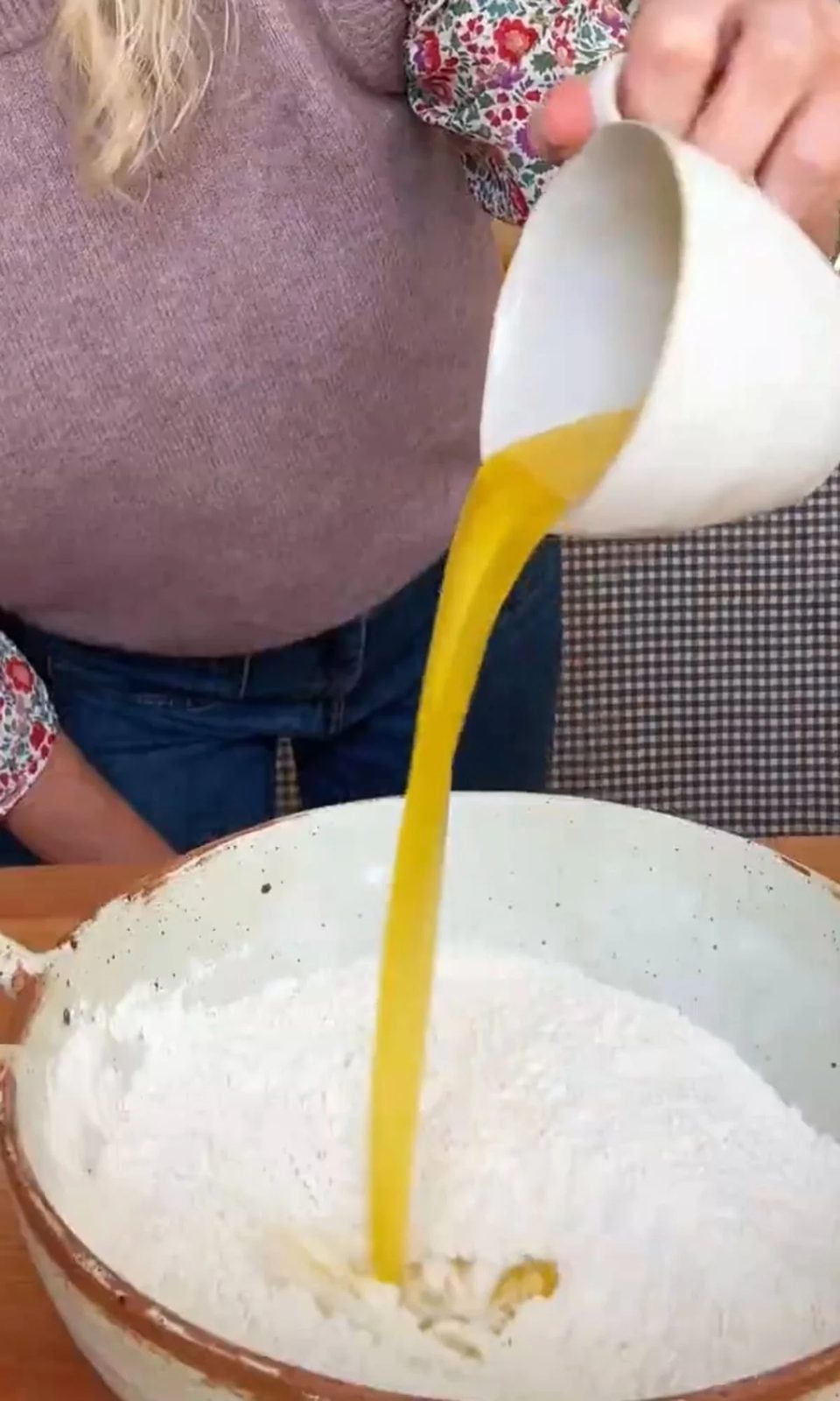 adding melted butter to pancakes.