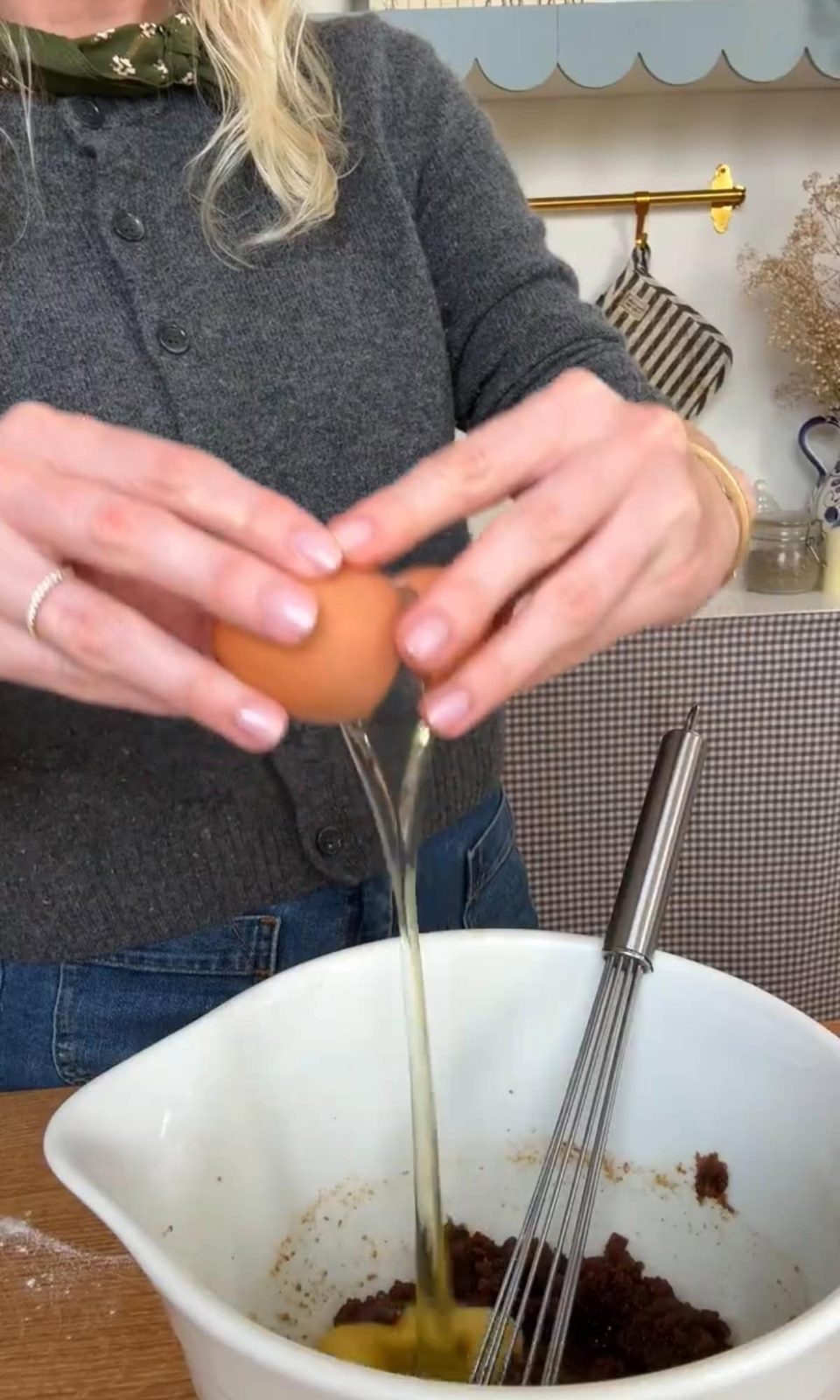 Cracking eggs into bowl for cookie dough.