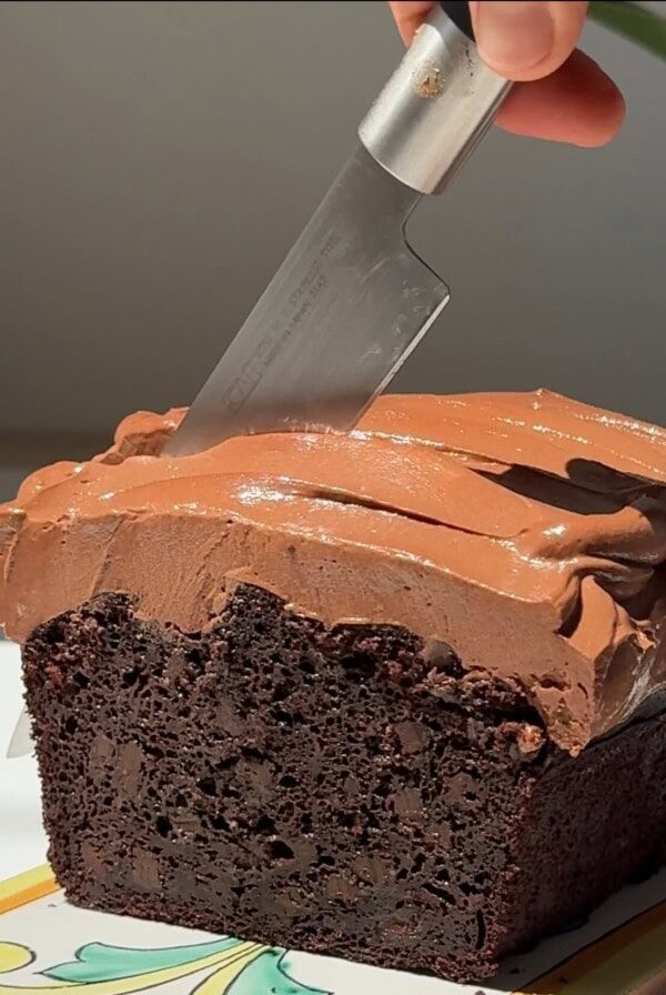 cutting chocolate courgette cake