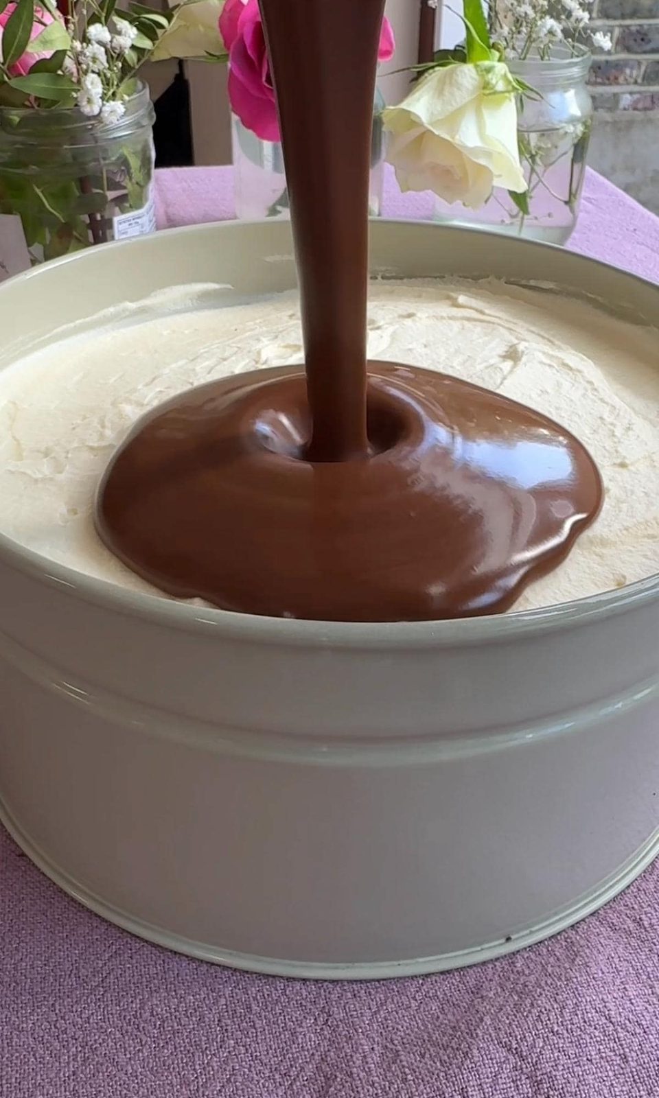 Pouring chocolate ganache on the dream cake.