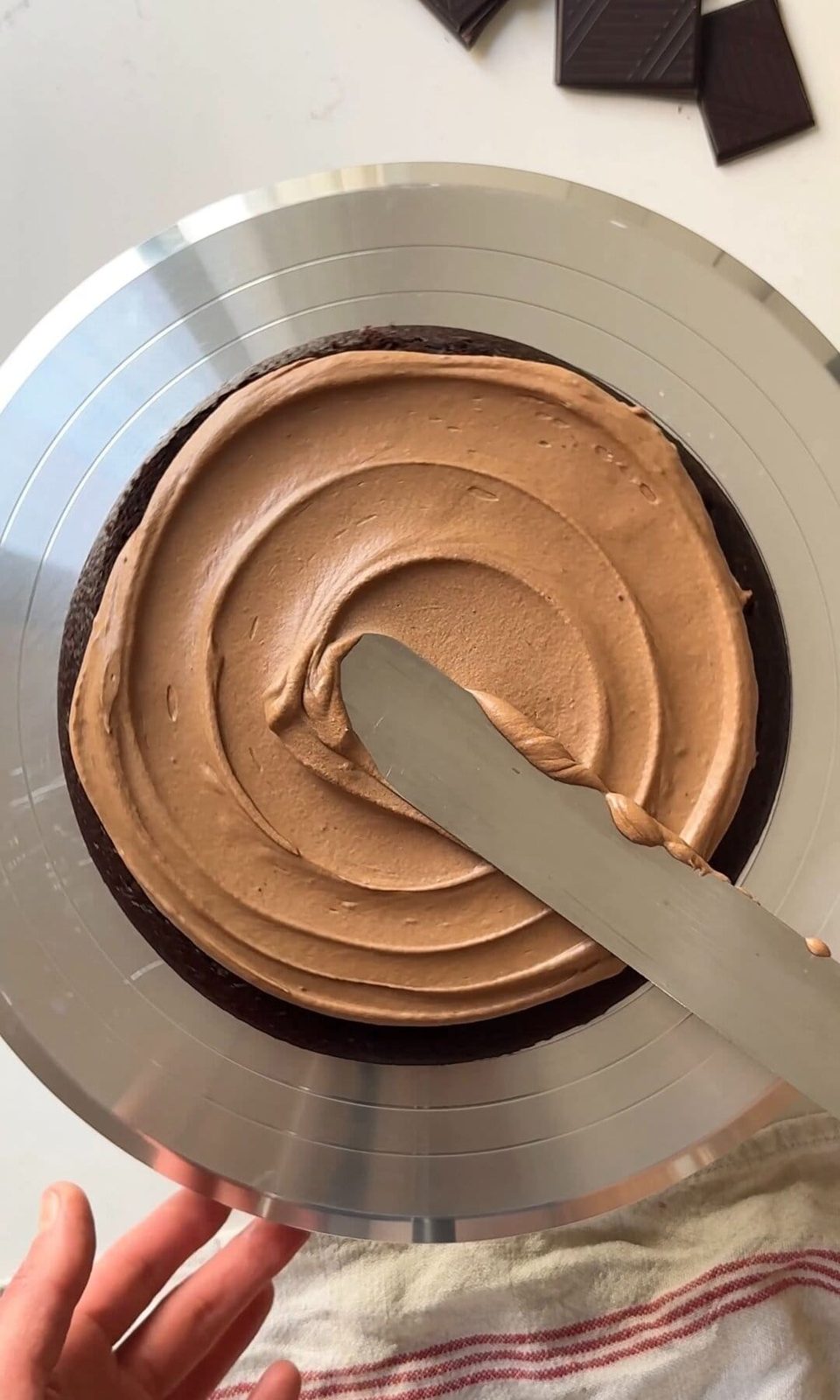 icing the chocolate fudge cake.