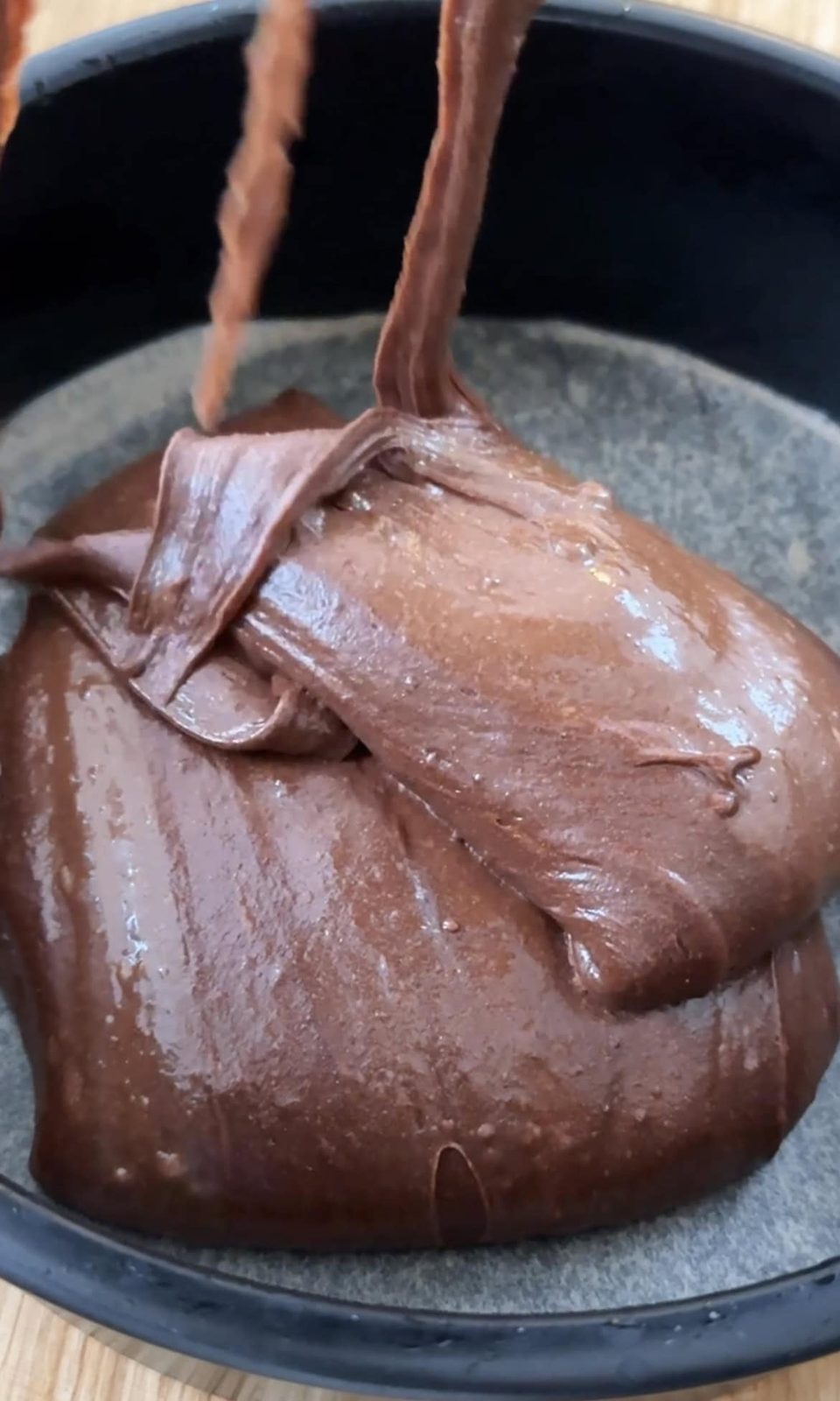 splitting cake batter into the cake tins.