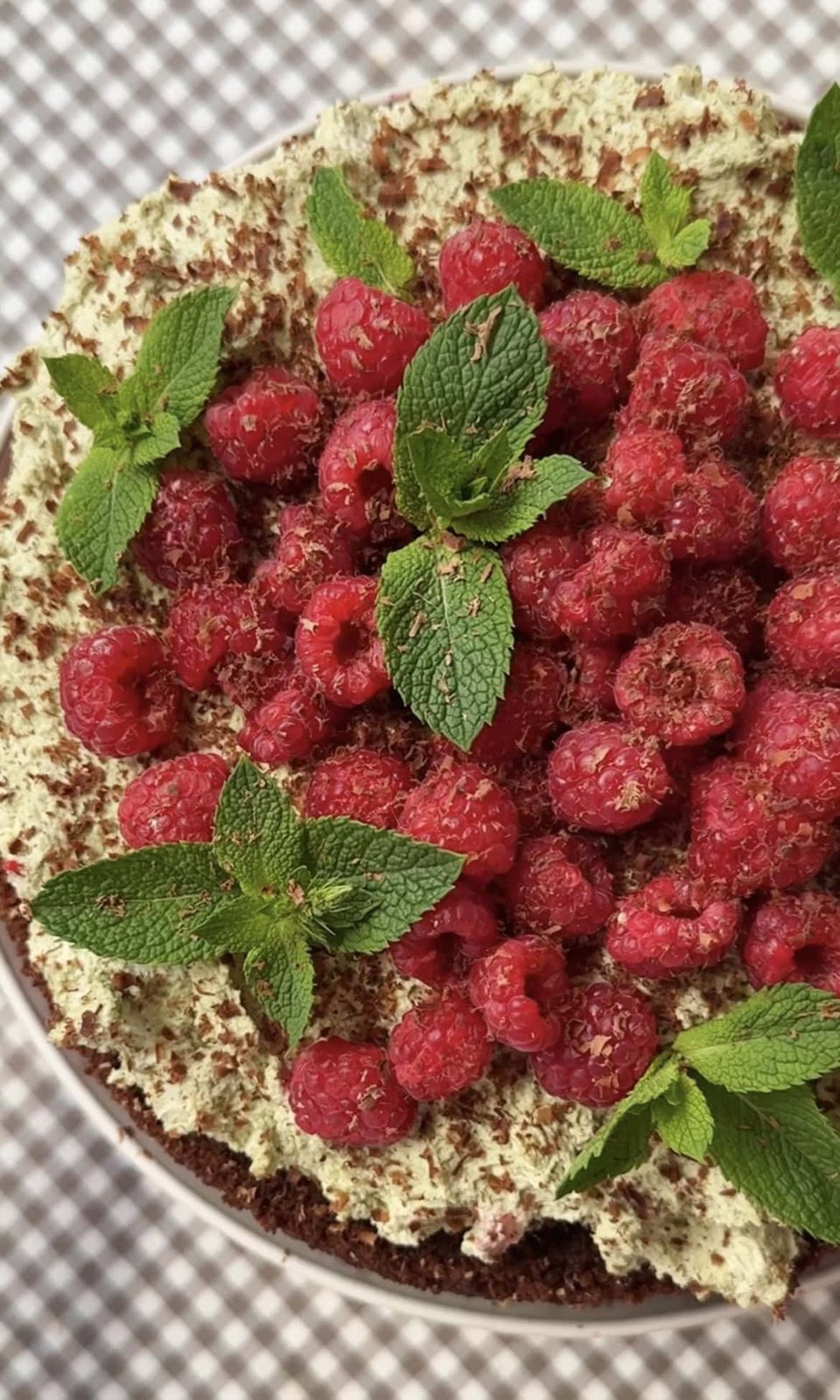 adding decoration to raspberry chocolate cake.