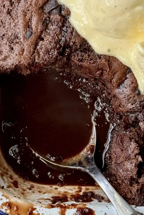 self saucing chocolate pudding in enamel dish with ice cream on top.