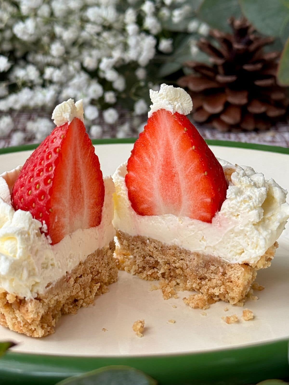 Cross section of Christmas cheesecake with strawberries on plate.