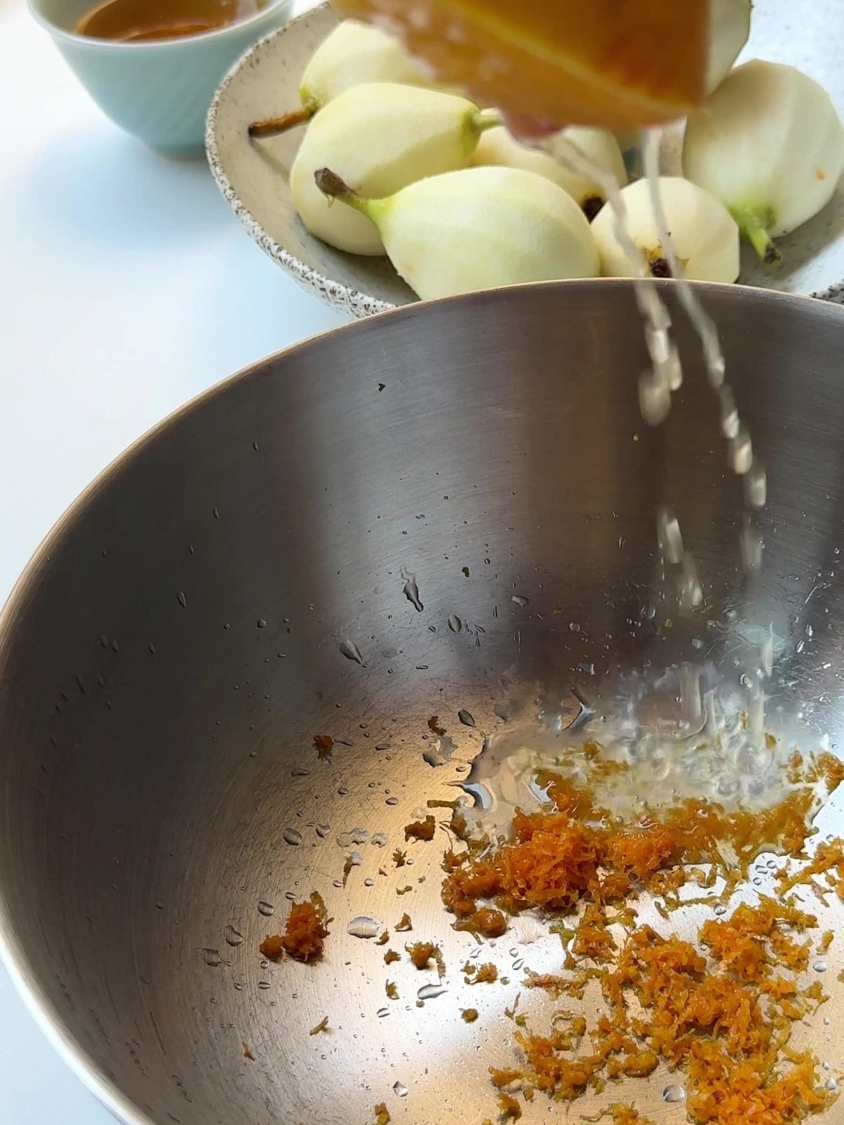 Orange zest and juice in a pot.