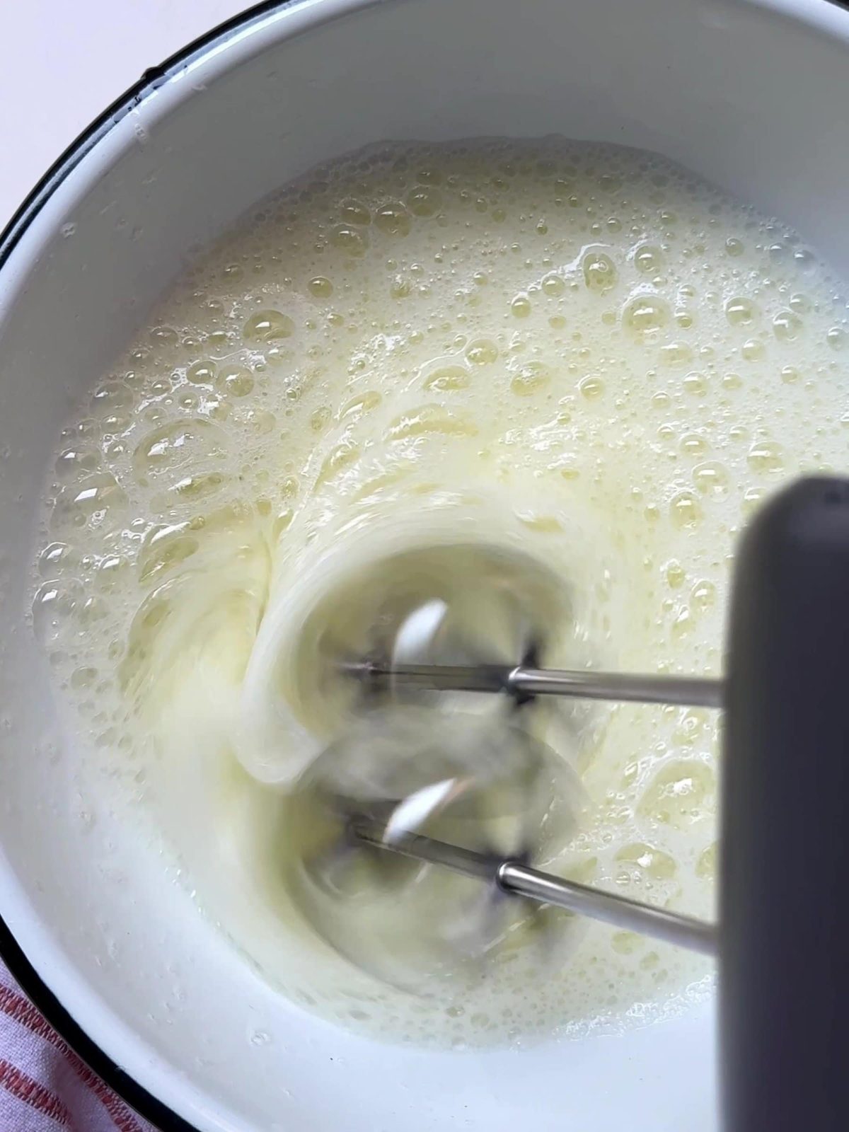 Mixing egg white with an electric whisk.