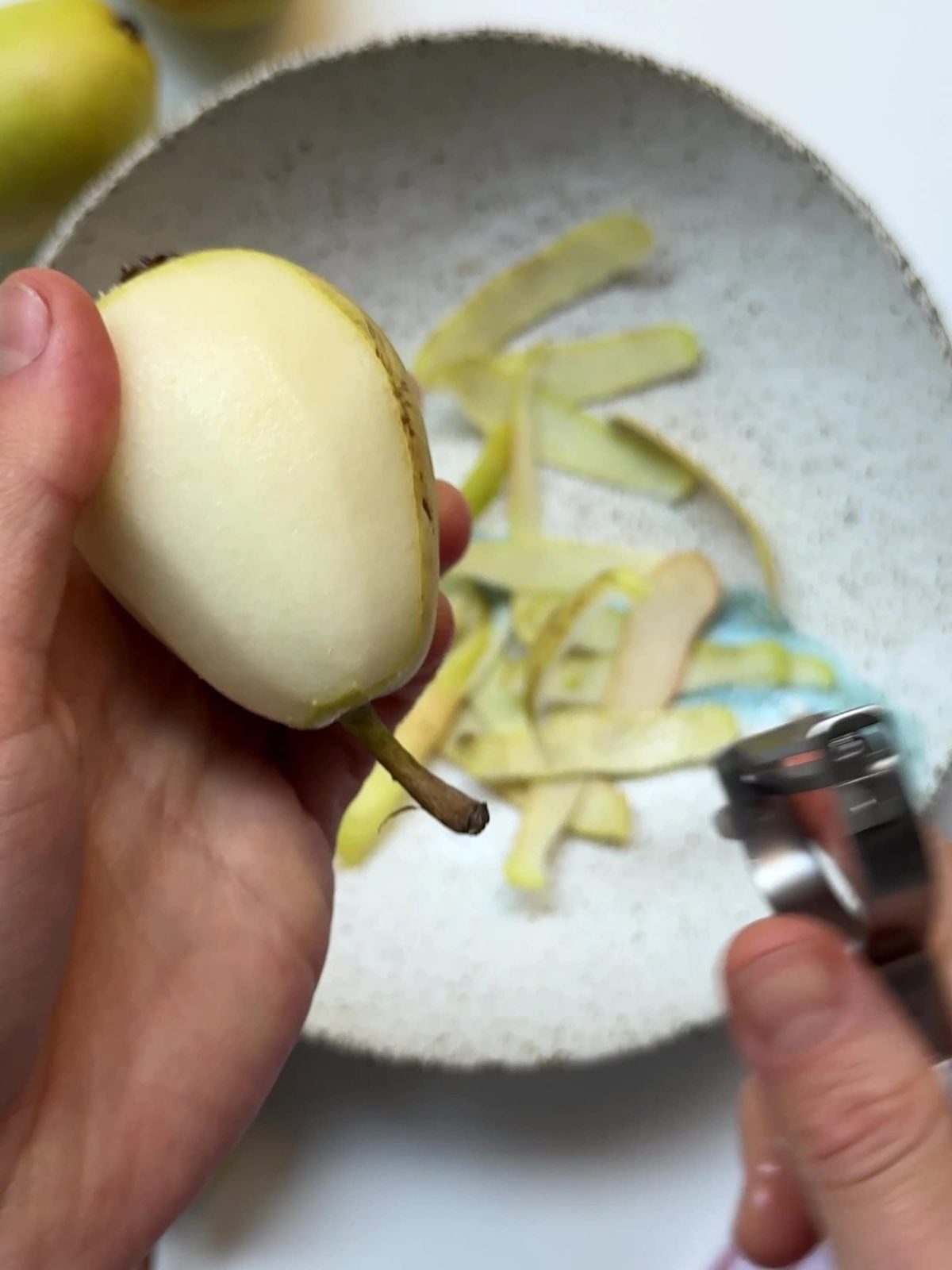 Peeling pears with a peeler.