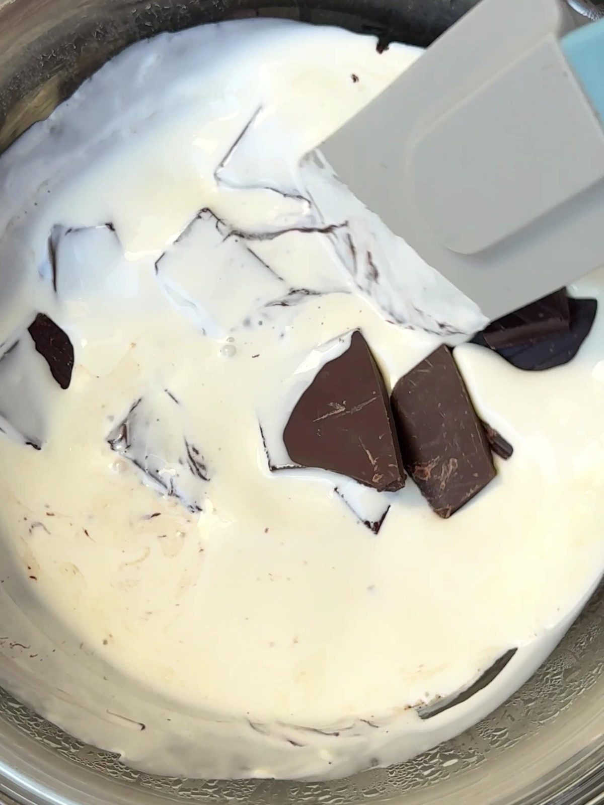 Adding chopped chocolate to cream.