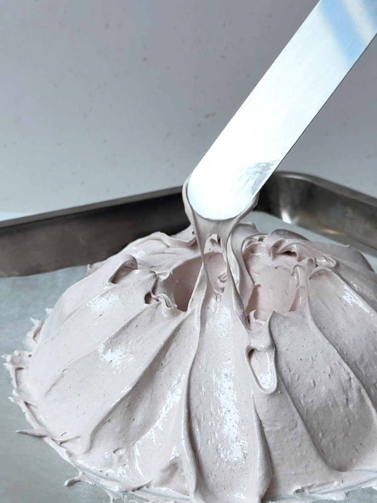 Forming the merengue into a pavlova shape.