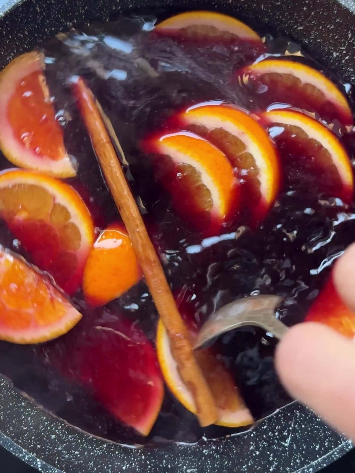 Slices of oranges and a cinnamon stick.