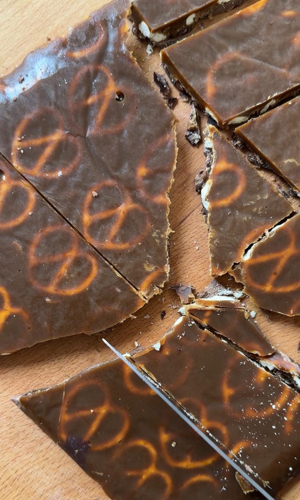 Breaking Christmas pretzel crack into shards.