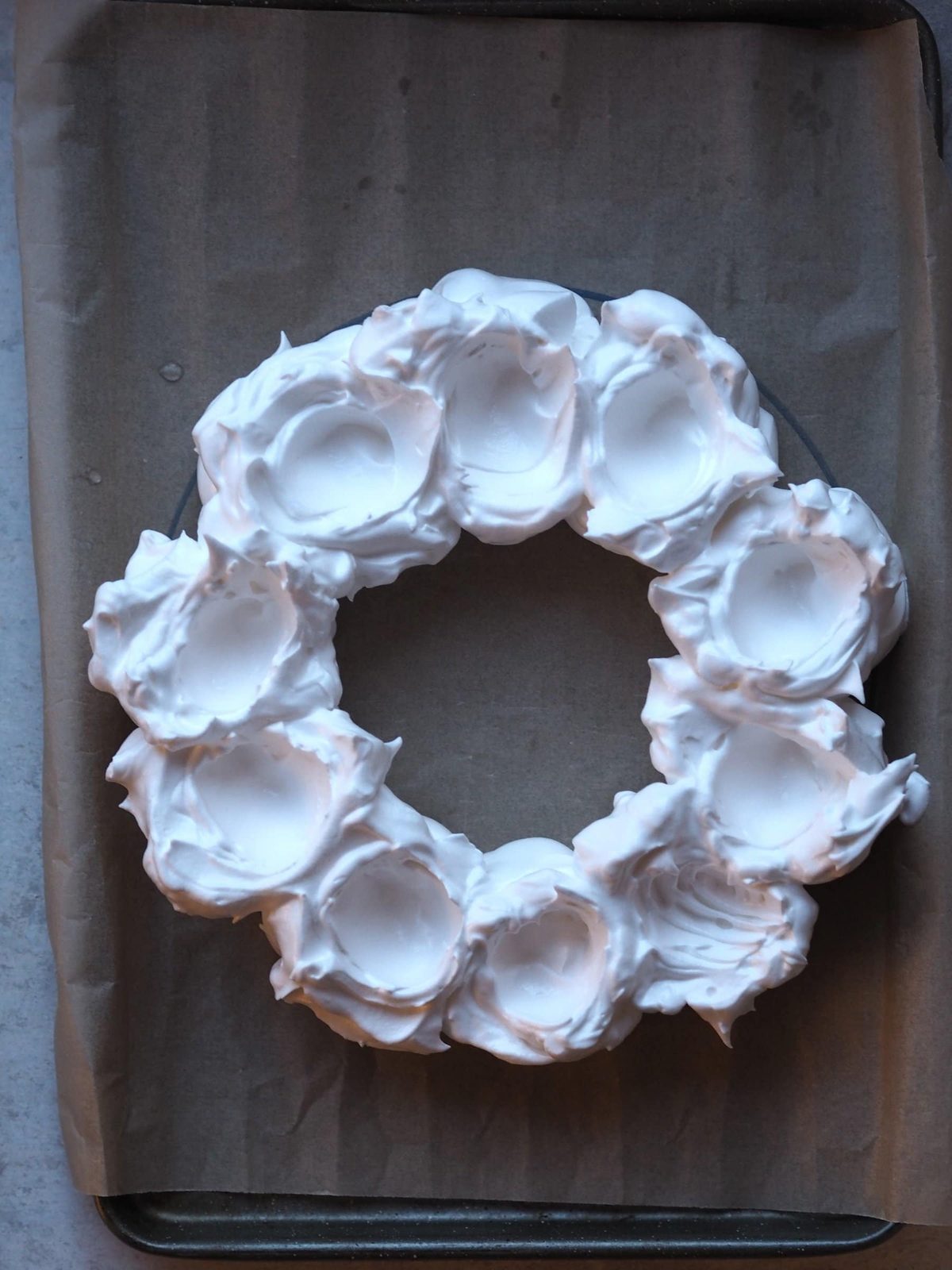 Flattening the meringue with a spoon