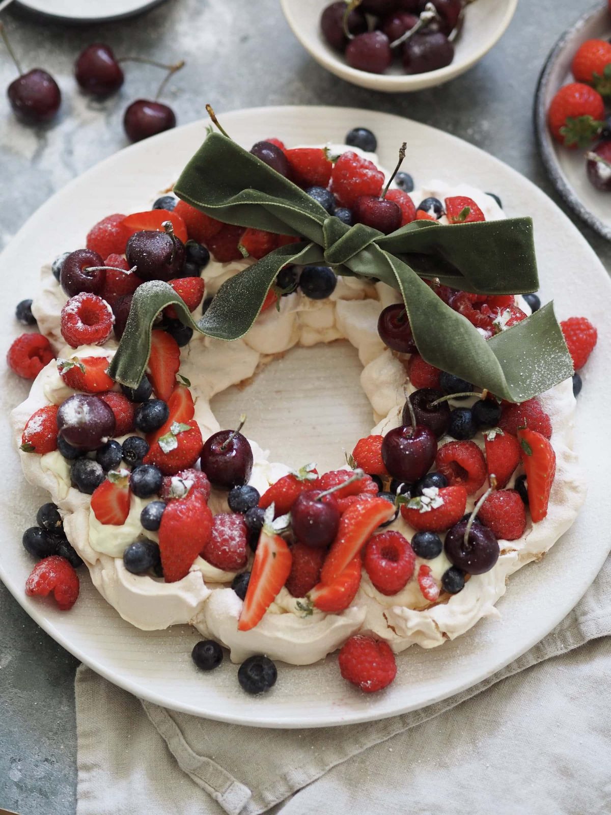 Christmas Pavlova on a plate with a ribbon.