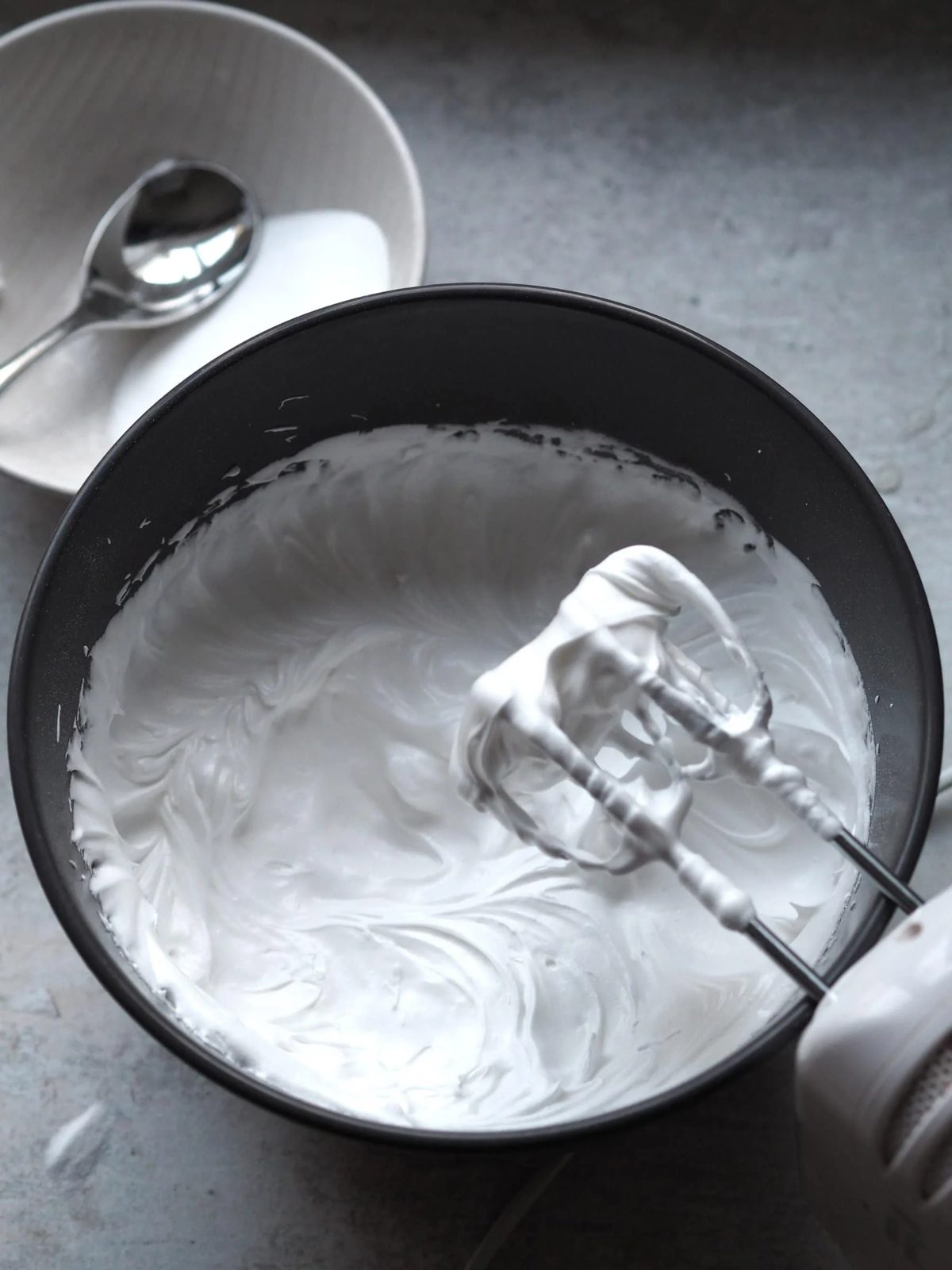 Whisking eggs with an electric blender.