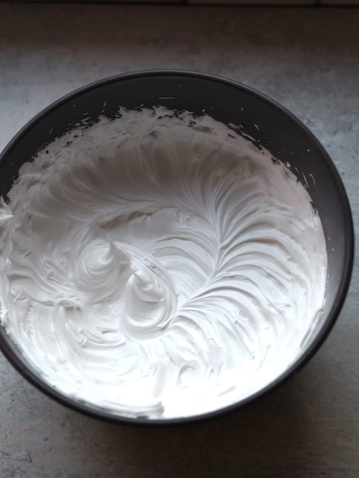 Whisked egg whites in a bowl.