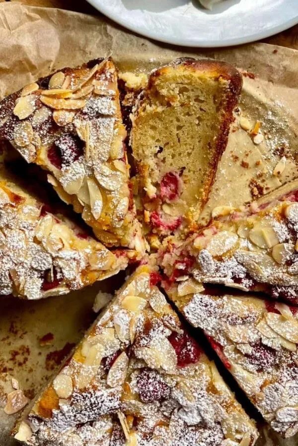 sliced Raspberry, Almond and Ricotta Cake on a plate.