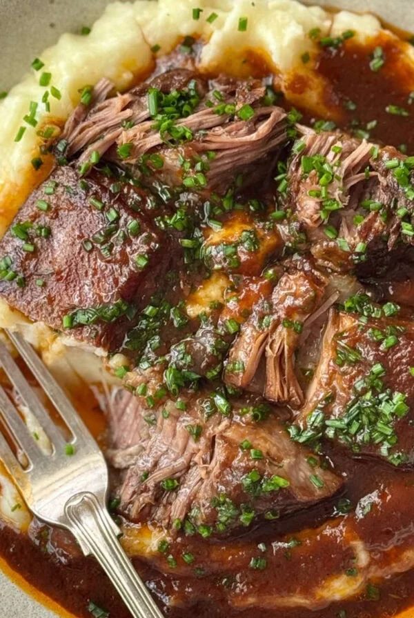 cooking beef short ribs served with mashed potato.