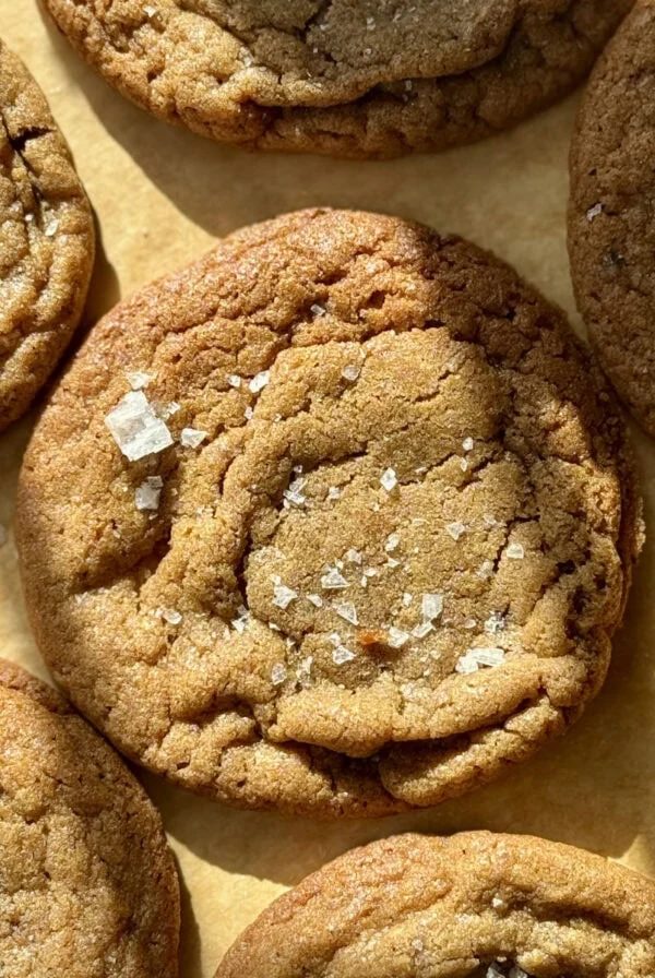 Freshly baked chocolate chipless cookies on parchment paper.