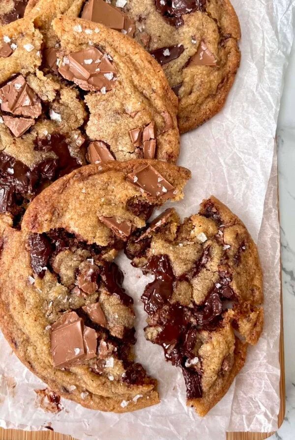 triple chocolate chunk cookies on parchment paper.