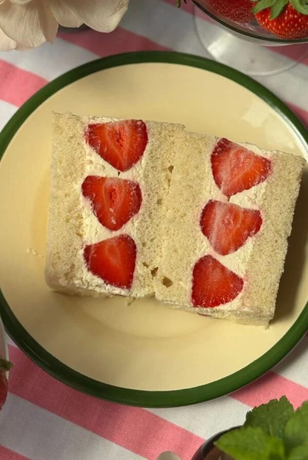 japan strawberry sandwich on a white plate with green rim.