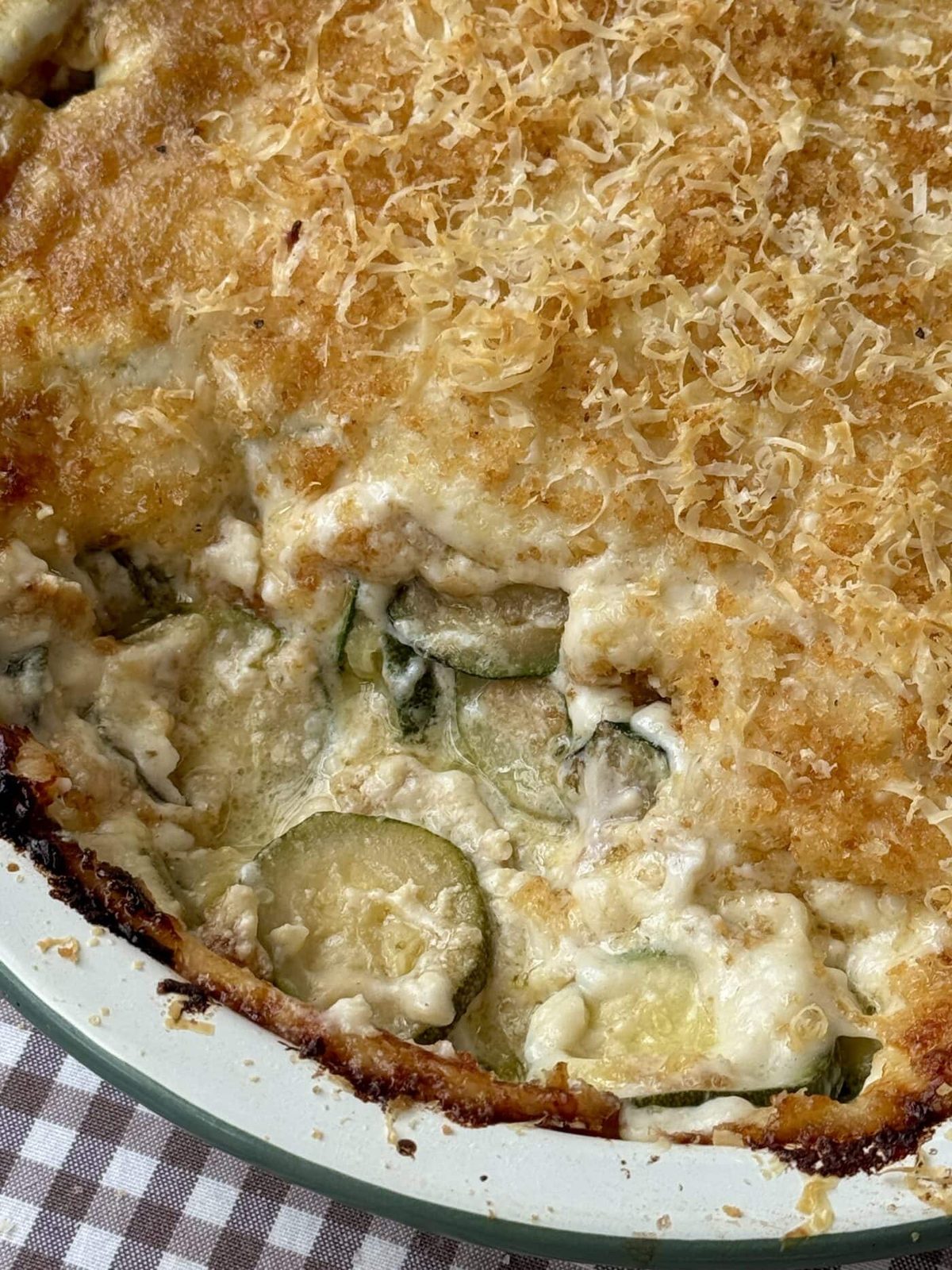 Gratin de courgettes in an enamel baking dish.
