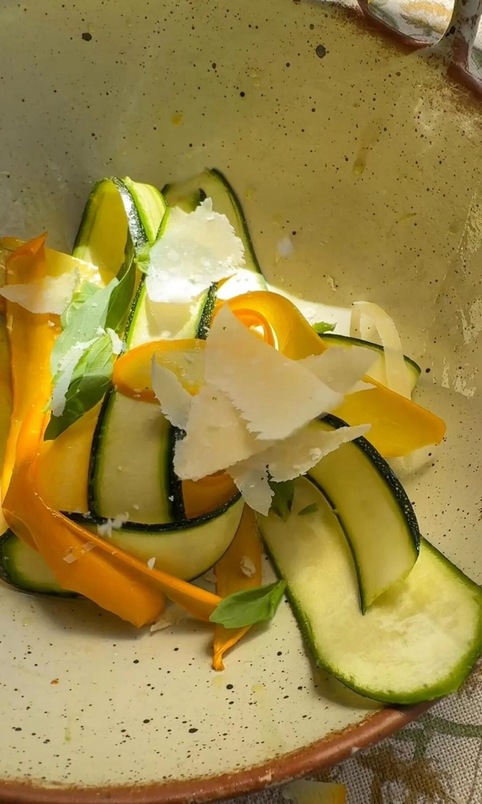 tossing courgette salad.