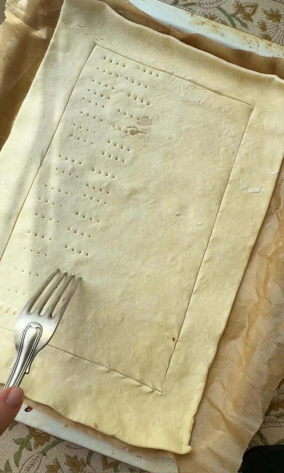 pricking the puff pastry with a fork.
