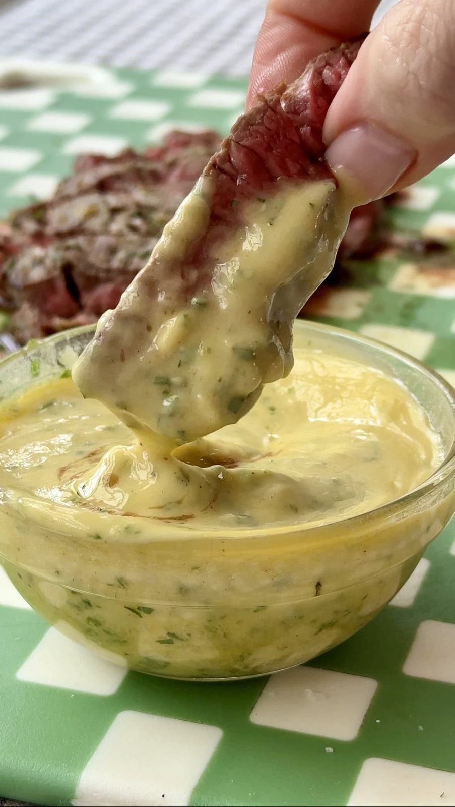 Dipping steak into cowboy butter.