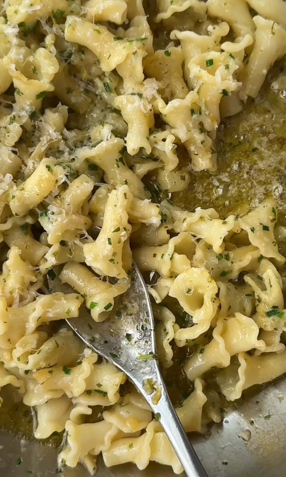 mixing pasta with cowboy butter.