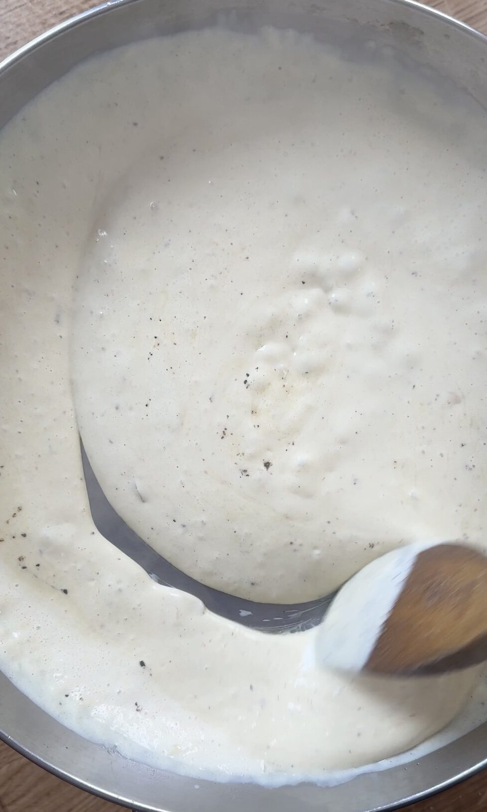 Stirring creamy chicken sauce.