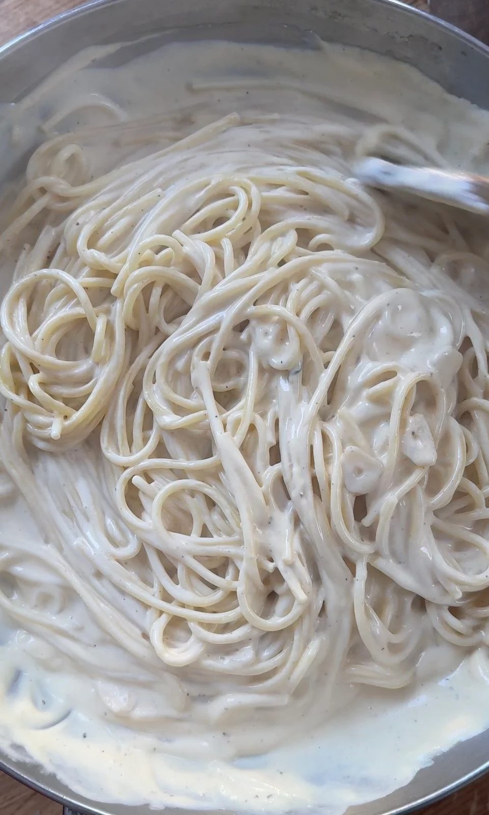 Stirring together creamy pasta.