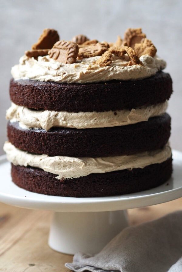 whole biscoff cake on a white cake stand.