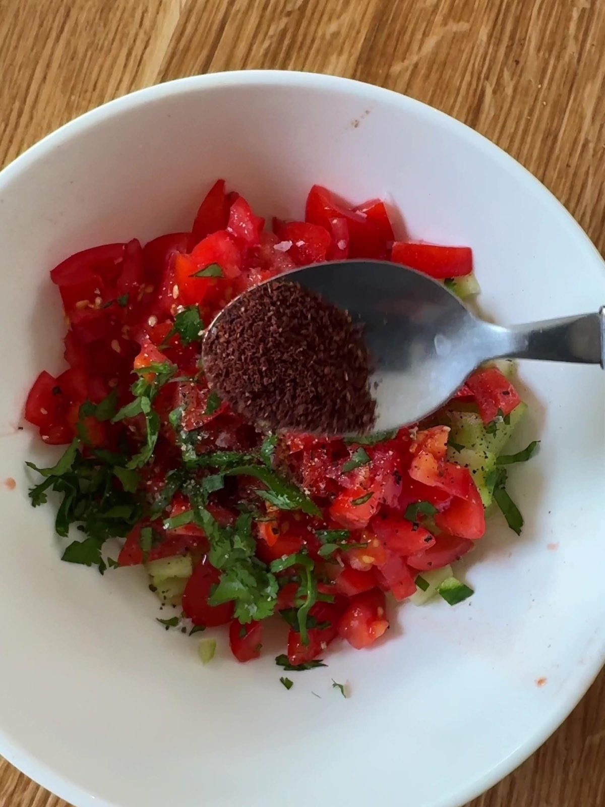 Making the tomato and cucumber salad.
