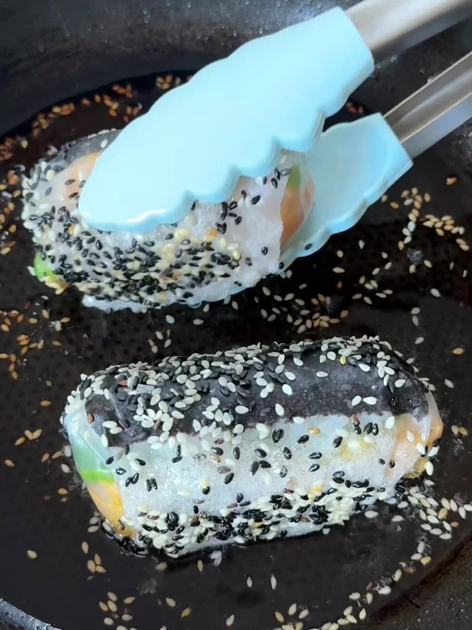 Frying tuna rolls in pan.