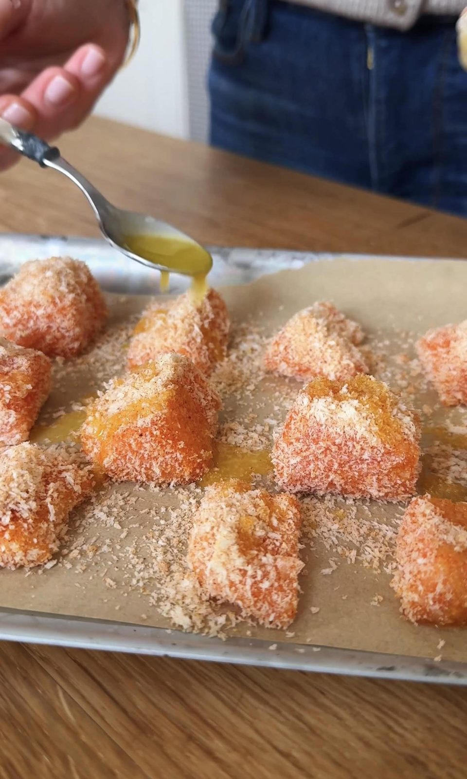 drizzling breaded salmon with butter.
