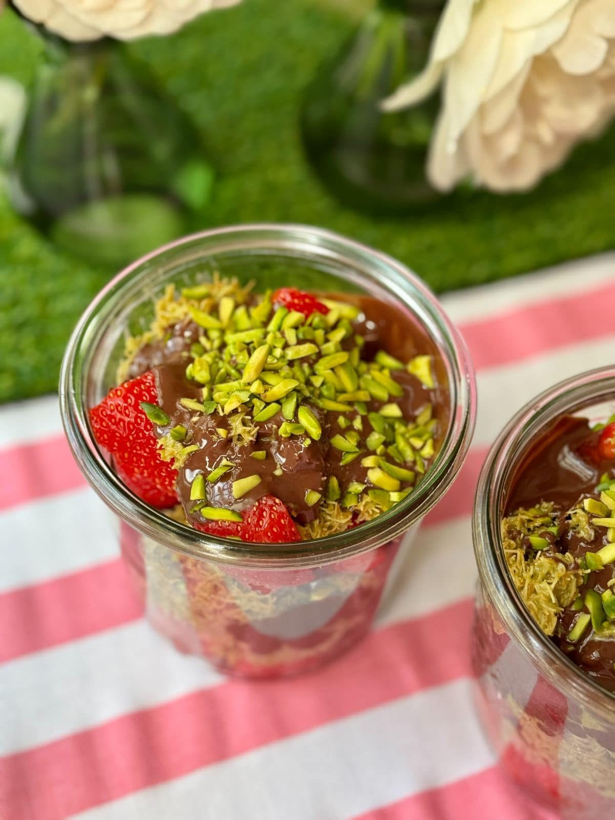 a glass filled with dubai chocolate strawberry.
